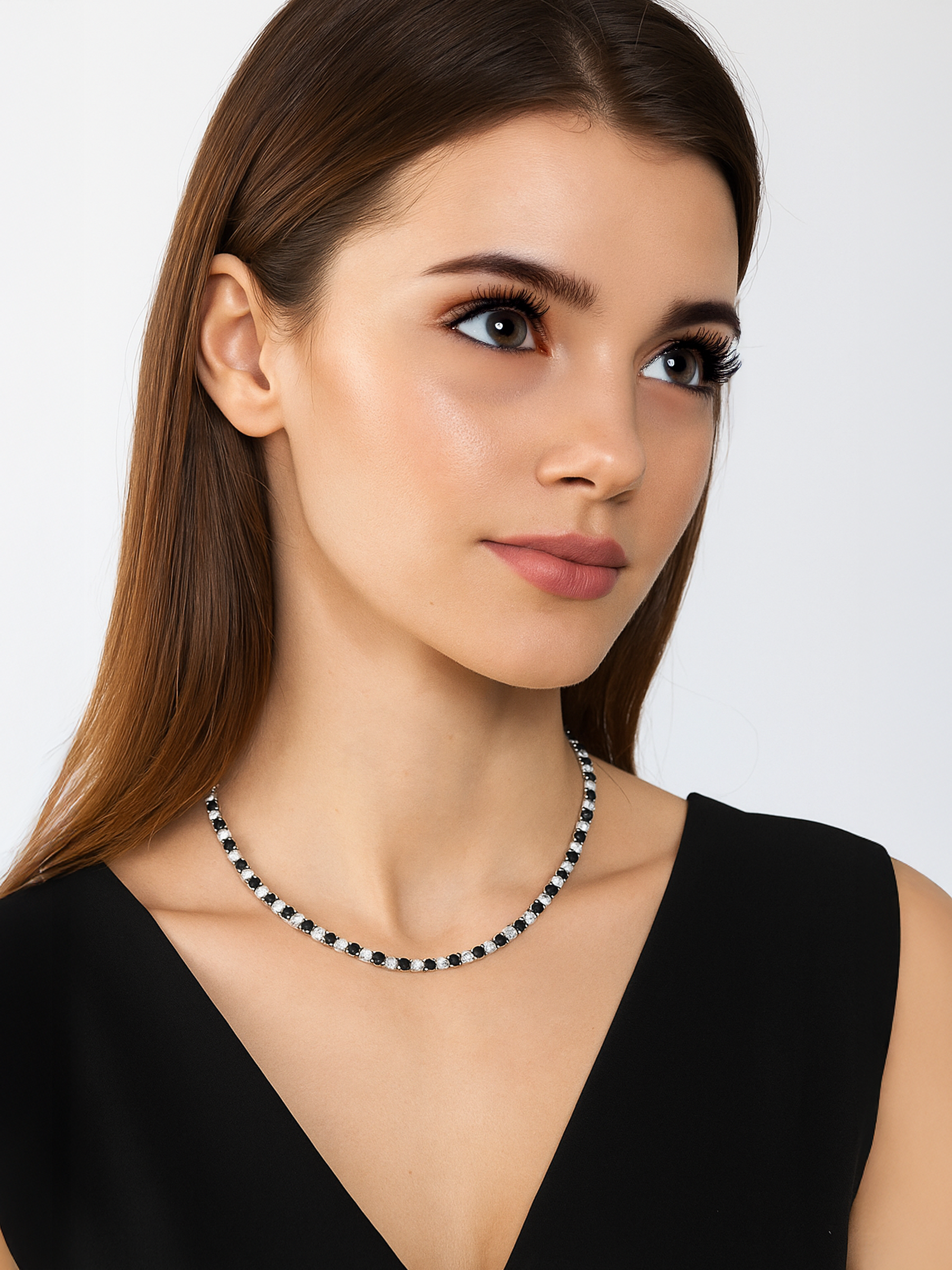 Woman wearing a black and white Tennis necklace