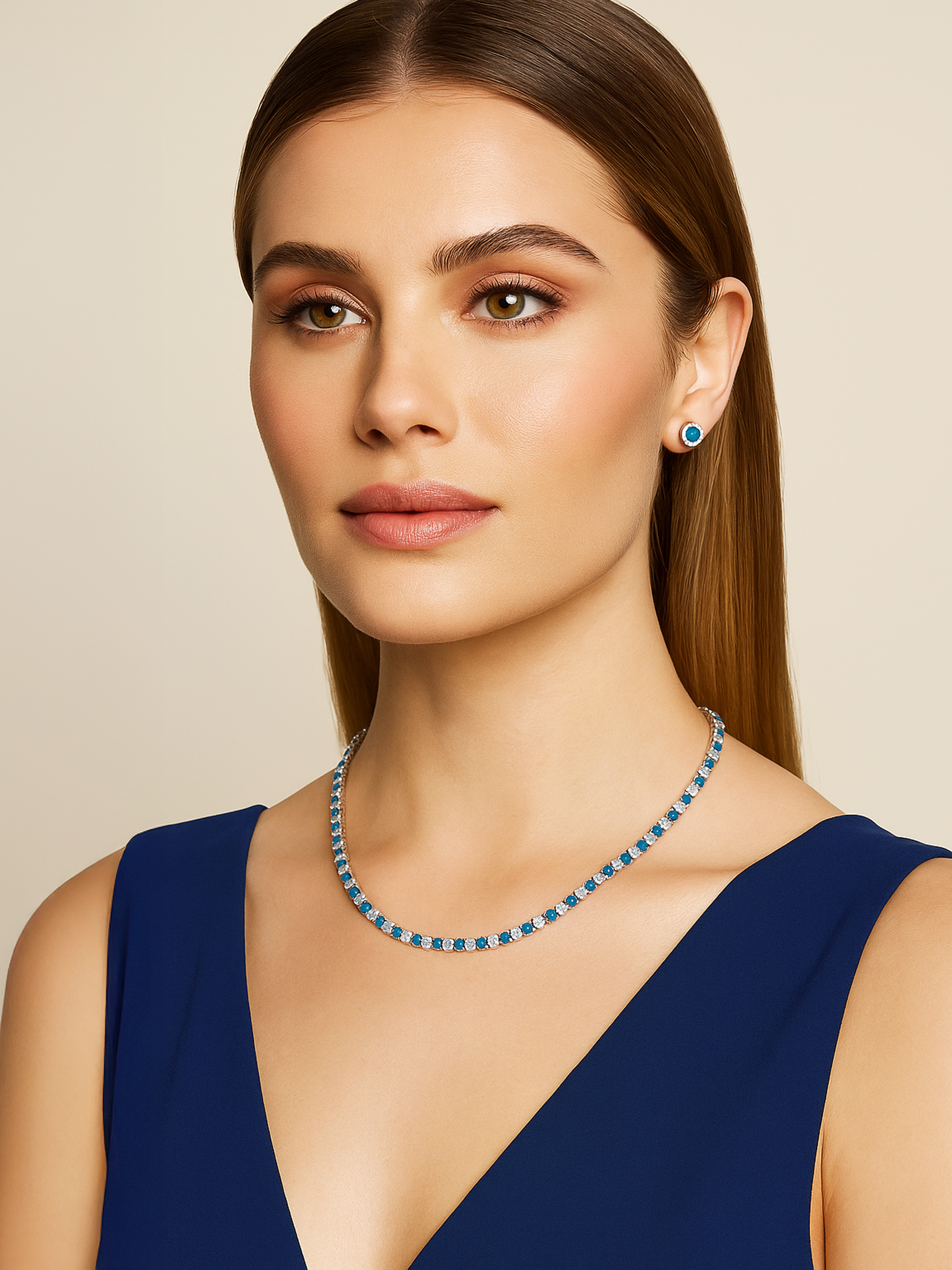 Woman wearing a blue and white Tennis necklace and earrings