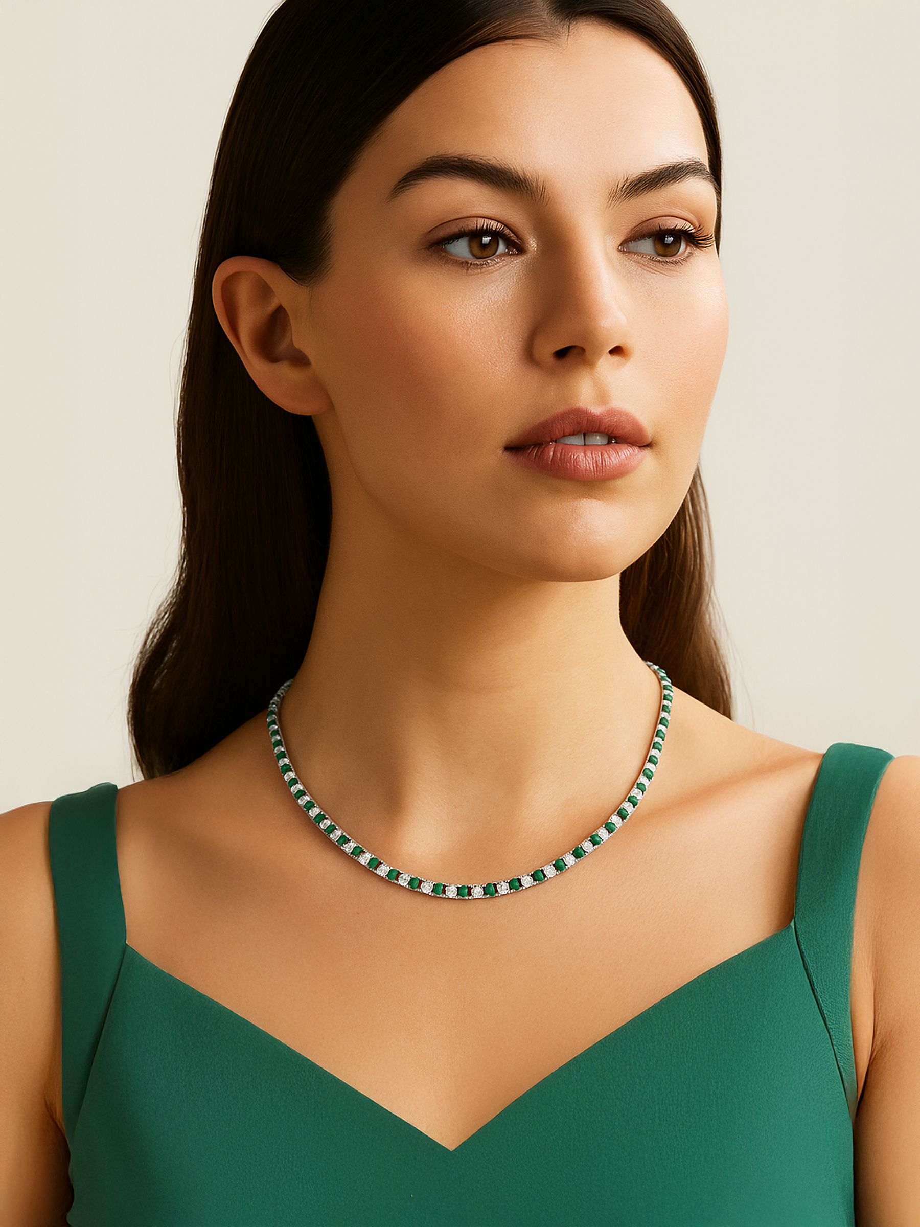 Woman wearing a green and white tennis necklace and earrings
