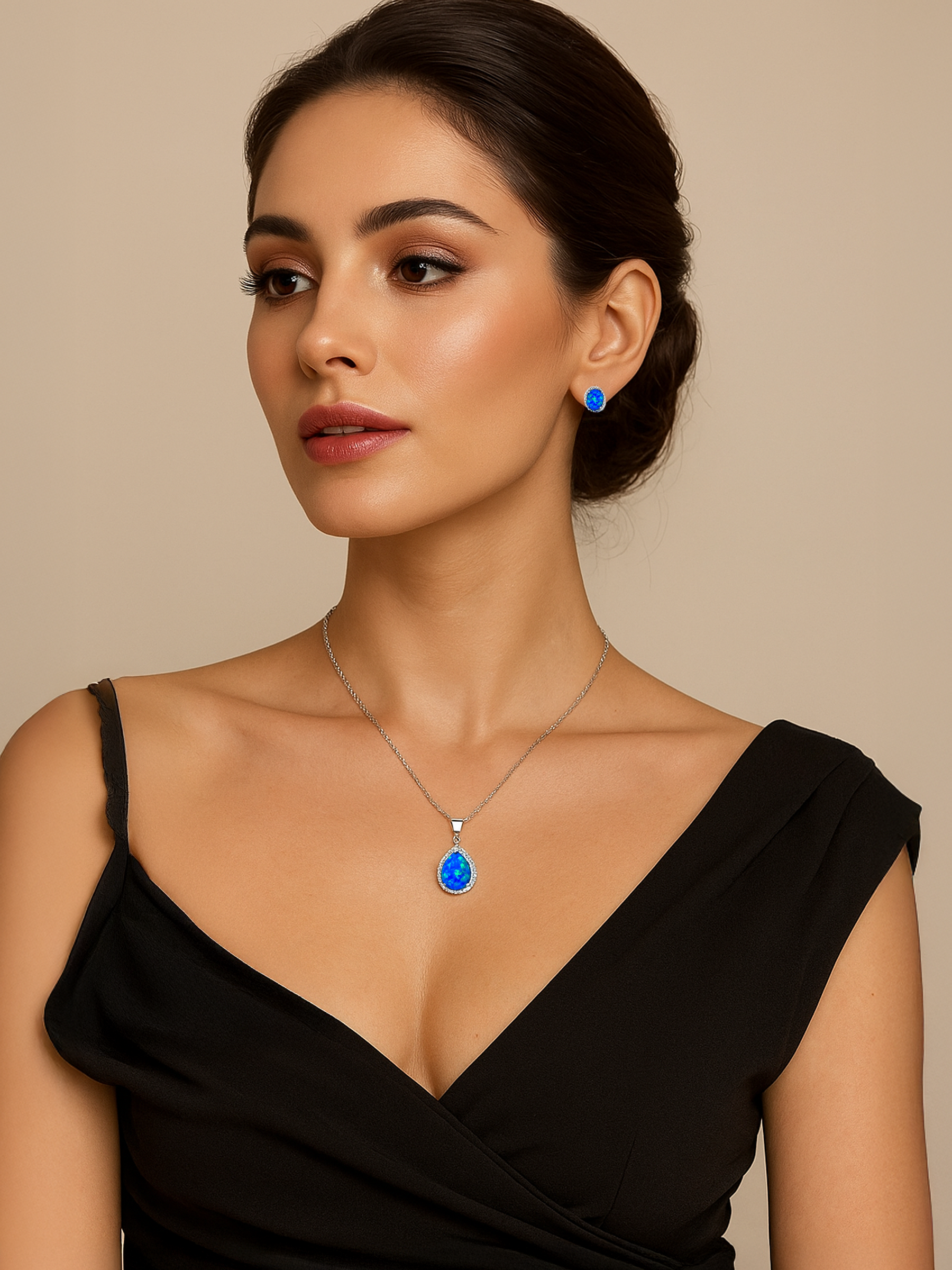 Woman wearing a black dress with a Blue Opal Pendant necklace