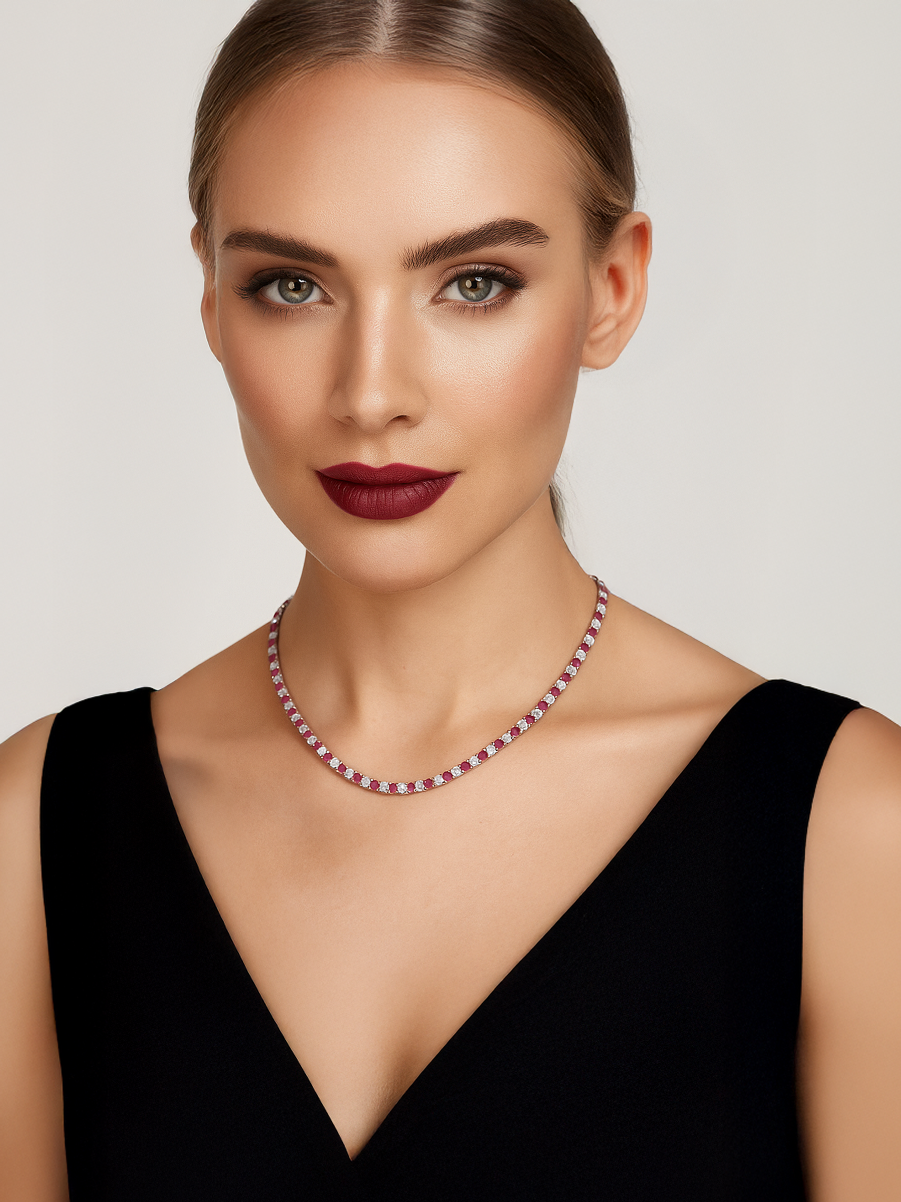 Woman wearing a red dress with red and white tennis necklace