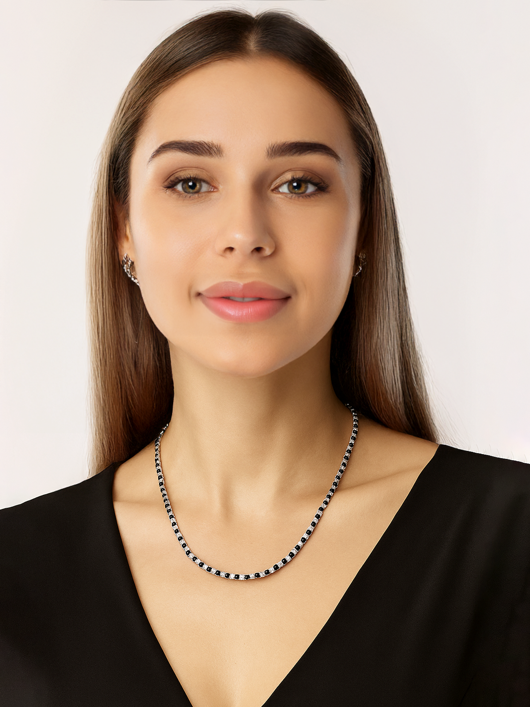 Woman wearing a black and white Tennis necklace